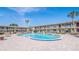 Community pool surrounded by brick pavers and lounge chairs in a well-maintained community on a sunny day at 5505 Hernandes Dr # 204, Orlando, FL 32808