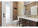 Stylish half-bath featuring floral wallpaper and vanity with dark wood and marble countertop at 618 Crownclover Ave, Orlando, FL 32828