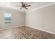 Neutral room with wood floors, shuttered window, and recessed lighting at 618 Crownclover Ave, Orlando, FL 32828
