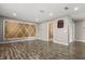 Spacious bonus room with decorative wall paneling, wood flooring, and access to a bathroom at 618 Crownclover Ave, Orlando, FL 32828