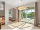Bright dining area with tile flooring, slider door access to the pool, and modern light fixture at 618 Crownclover Ave, Orlando, FL 32828