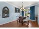 Well-lit dining room featuring large windows, a modern chandelier, and stylish decor at 618 Crownclover Ave, Orlando, FL 32828