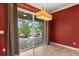 Dining area with a pool view through sliding glass doors, and a modern chandelier at 618 Crownclover Ave, Orlando, FL 32828