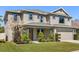 Charming two-story home with lush landscaping, a two-car garage, and a covered front porch at 618 Crownclover Ave, Orlando, FL 32828