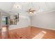 Open living space with hardwood floors, decorative ceiling and fan, and staircase at 618 Crownclover Ave, Orlando, FL 32828