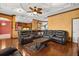 Luxurious living room with a large leather sectional and an elegant decorative ceiling at 618 Crownclover Ave, Orlando, FL 32828