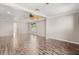 Spacious living room featuring wood floors, neutral paint, modern ceiling fan, and recessed lighting at 618 Crownclover Ave, Orlando, FL 32828