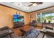 Comfortable living room featuring a cozy recliner, entertainment center, and a decorative ceiling at 618 Crownclover Ave, Orlando, FL 32828
