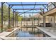 Relaxing screened-in pool area featuring a hot tub and well-manicured greenery at 618 Crownclover Ave, Orlando, FL 32828
