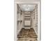 Walk-in closet with custom shelving, storage, wood floors, and decorative chandelier at 618 Crownclover Ave, Orlando, FL 32828