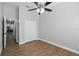 Neutral bedroom with ceiling fan, wood-look floors, and a closet at 751 Via Milano, Apopka, FL 32712