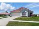 Charming single-story home with a red tile roof, well-manicured lawn, and an attached two-car garage at 751 Via Milano, Apopka, FL 32712