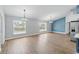 Spacious living room with two windows and wood-look flooring throughout at 751 Via Milano, Apopka, FL 32712