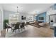 Living and dining area with wood floors, recessed lights, furniture, dining table, and lots of natural light at 751 Via Milano, Apopka, FL 32712