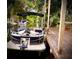 Pontoon boat docked with water access, perfect for enjoying peaceful days on the serene canal at 76 Oakdale St, Windermere, FL 34786