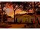 Town Hall with holiday decorations and string lights glowing in front of a colorful sunset at 76 Oakdale St, Windermere, FL 34786
