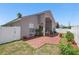 A well-manicured backyard features a brick patio, privacy fence, and colorful landscaping at 9915 Kona Isle Ct, Orlando, FL 32817