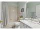 Bright bathroom with shower-tub combo, white vanity, and updated fixtures at 9915 Kona Isle Ct, Orlando, FL 32817