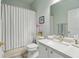 Bright bathroom with shower-tub combo, white vanity, and updated fixtures at 9915 Kona Isle Ct, Orlando, FL 32817