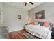Cozy bedroom with hardwood floors, daybed, and stylish decor for a relaxing ambiance at 9915 Kona Isle Ct, Orlando, FL 32817