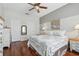 A bright bedroom with hardwood floors, a ceiling fan, and two closets at 9915 Kona Isle Ct, Orlando, FL 32817