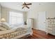 A bright bedroom with hardwood floors and a ceiling fan at 9915 Kona Isle Ct, Orlando, FL 32817