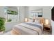 This bedroom is staged with modern decor, neutral colors, and a bright window at 9915 Kona Isle Ct, Orlando, FL 32817