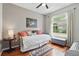 Cozy bedroom with hardwood floors, neutral colors, a large window and soft lighting, creating a comfortable atmosphere at 9915 Kona Isle Ct, Orlando, FL 32817