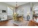Formal dining room featuring a chandelier, patterned rug, and views to the living room at 9915 Kona Isle Ct, Orlando, FL 32817