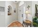 Welcoming foyer with decorative tile flooring, arched doorway and nook, and stylish furnishings at 9915 Kona Isle Ct, Orlando, FL 32817
