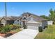 Beautiful home featuring manicured landscaping and an architectural design with a front entry garage at 9915 Kona Isle Ct, Orlando, FL 32817