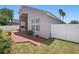 Rear exterior view of the home showcasing a brick patio, fenced yard, and well-maintained landscaping at 9915 Kona Isle Ct, Orlando, FL 32817