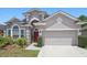 Beautiful home featuring manicured landscaping and an architectural design with a front entry garage at 9915 Kona Isle Ct, Orlando, FL 32817