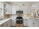 Bright kitchen with stainless steel appliances, tile floors and light counter tops at 9915 Kona Isle Ct, Orlando, FL 32817