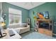 Bright room featuring a striped couch, green walls, large window, and a ceiling fan at 9915 Kona Isle Ct, Orlando, FL 32817