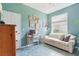 Bright room featuring a striped couch, turquoise walls, and a large window at 9915 Kona Isle Ct, Orlando, FL 32817