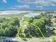 Expansive aerial view of waterfront property with lush landscaping, private dock and natural surroundings in a serene setting at 1003 Shore Dr, Kissimmee, FL 34744