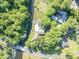 Overhead shot of residence surrounded by lush greenery, including a pool, yard and canal at 1003 Shore Dr, Kissimmee, FL 34744