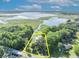 Waterfront estate aerial showcasing the expansive property, lake access, surrounded by lush greenery offering a serene and picturesque landscape at 1003 Shore Dr, Kissimmee, FL 34744