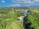 A beautiful home sits on a large lot with mature trees and water access at 1003 Shore Dr, Kissimmee, FL 34744