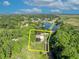 A beautiful home sits on a large lot with mature trees and water access at 1003 Shore Dr, Kissimmee, FL 34744