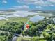 Aerial view of the home on a tree-lined waterfront, marked by a red pin at 1003 Shore Dr, Kissimmee, FL 34744