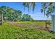Expansive backyard with lush green grass and wooden perimeter fence, perfect for outdoor activities and enjoying nature at 1003 Shore Dr, Kissimmee, FL 34744