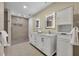 Modern bathroom featuring a double vanity, marble countertops, a large walk-in shower, and stylish finishes at 1003 Shore Dr, Kissimmee, FL 34744