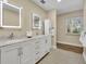 Bright bathroom with marble countertop, double sinks, and modern lighting at 1003 Shore Dr, Kissimmee, FL 34744
