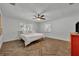 Well lit bedroom with herringbone floors, fan, and dual windows at 1003 Shore Dr, Kissimmee, FL 34744