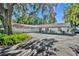 A large one-story home with a three-car garage and a paved driveway surrounded by lush greenery at 1003 Shore Dr, Kissimmee, FL 34744