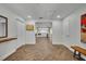 Bright foyer with herringbone floors leads to kitchen featuring modern appliances at 1003 Shore Dr, Kissimmee, FL 34744