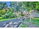 Long driveway leading to a home with lush tropical landscaping at 1003 Shore Dr, Kissimmee, FL 34744