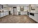 Modern kitchen with stainless steel appliances, wine rack, and herringbone floors at 1003 Shore Dr, Kissimmee, FL 34744